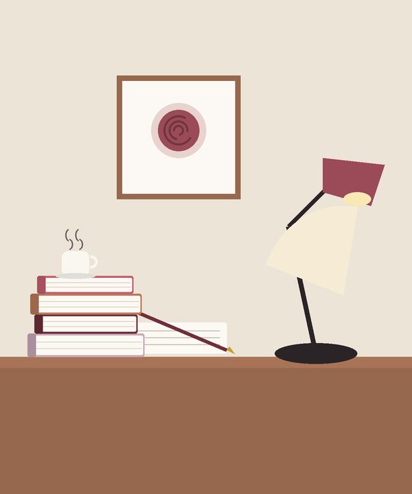 مكتبٌ عليه مصباحٌ ودفترٌ وكتب