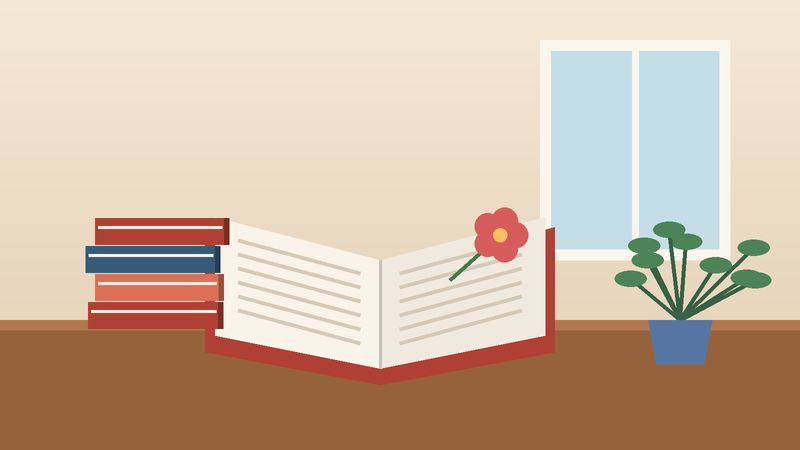 كتابٌ مفتوح عليه زهرةٌ مجفّفة قرب نافذة