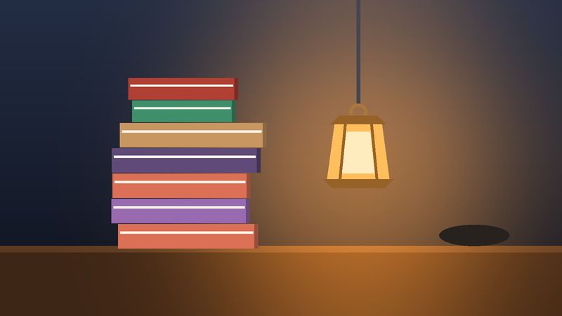 كتبٌ قديمة مكدّسة تحت قنديلٍ مضيء