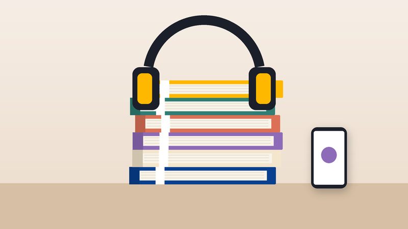 سمّاعتان فوق كتبٍ مكدّسة
