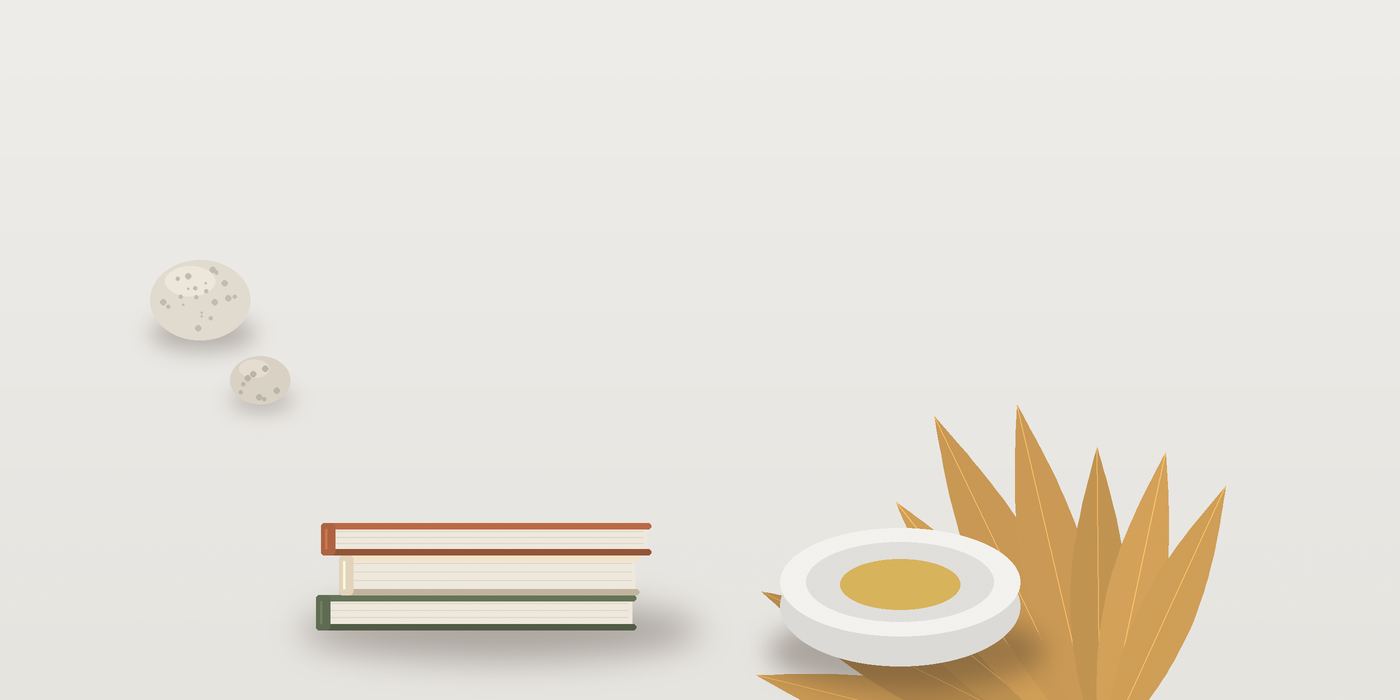 كتبٌ مكدّسة وطبقٌ وحصى على سطحٍ أبيض