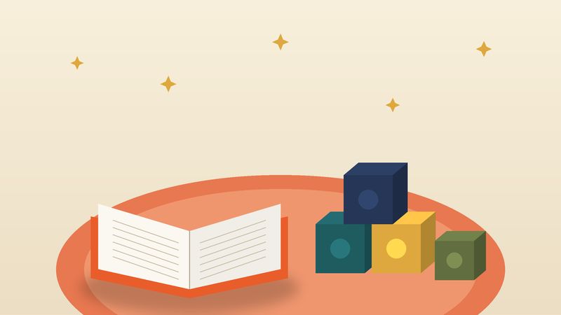 كتابٌ مفتوح ومكعّباتٌ ملوّنة على سجّادة